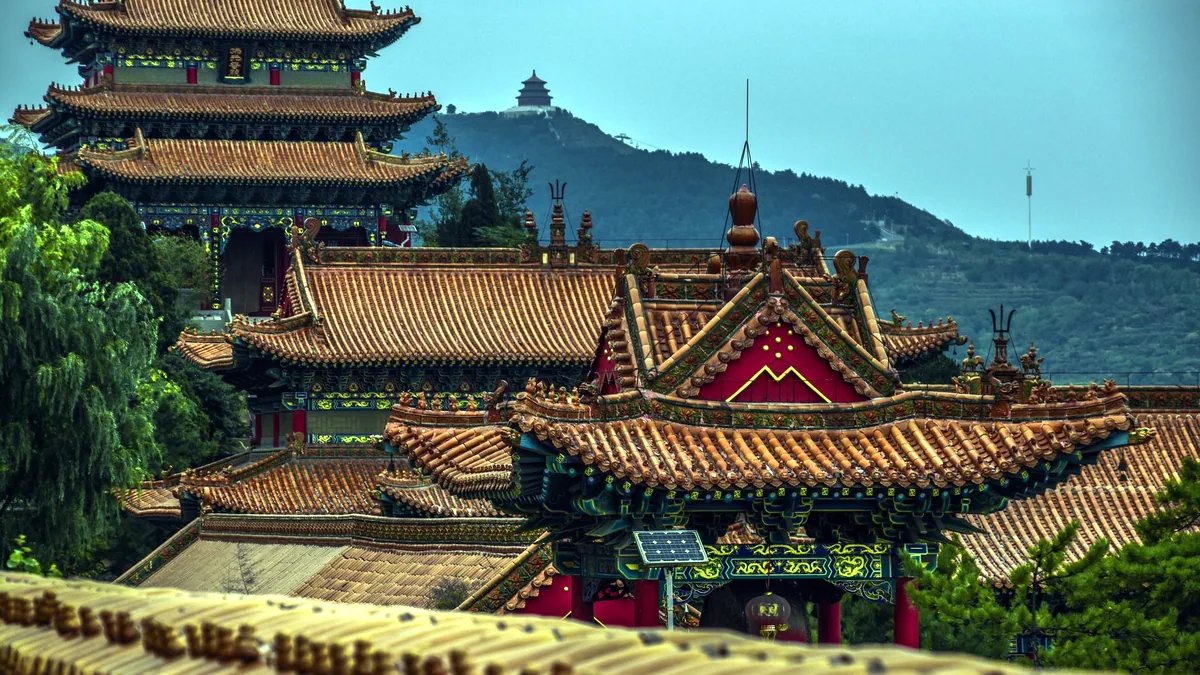 The curved red roof of a traditional Chinese pagoda.