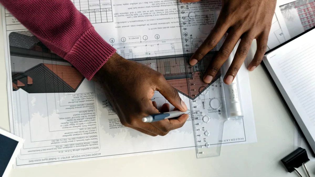 A detailed blueprint drawing of a building spread across a table.