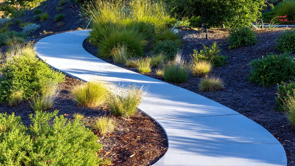 A garden path winding through a landscaped green landscape.
