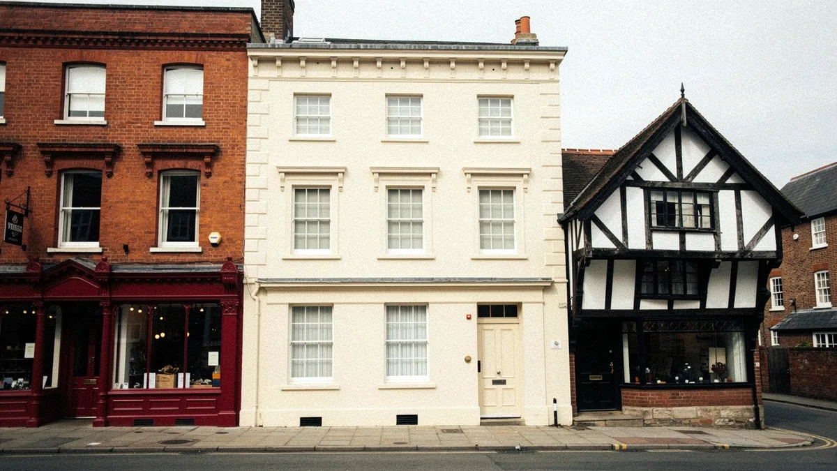 Illustration: A street corner with a red brick Victorian shopfront beside a rendered Georgian townhouse.